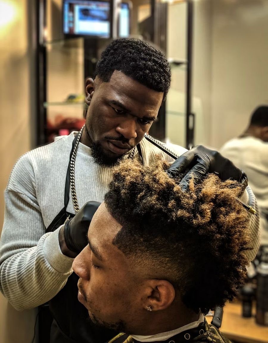 Barber giving a client a fresh cut in a busy barbershop