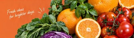 Oranges, tomatoes, fresh leaves and purple cabbage. Fresh ideas for brighter days.