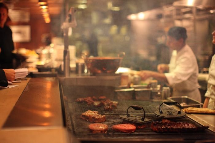 Chef preparing fresh food on a restaurant grill