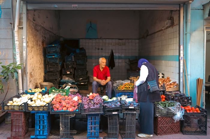 Greengrocer with crates of fresh produce