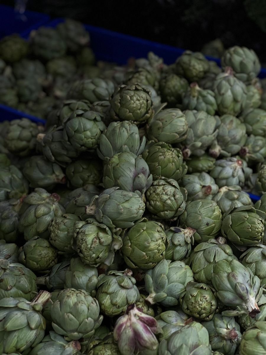 Fresh artichokes in a market crate